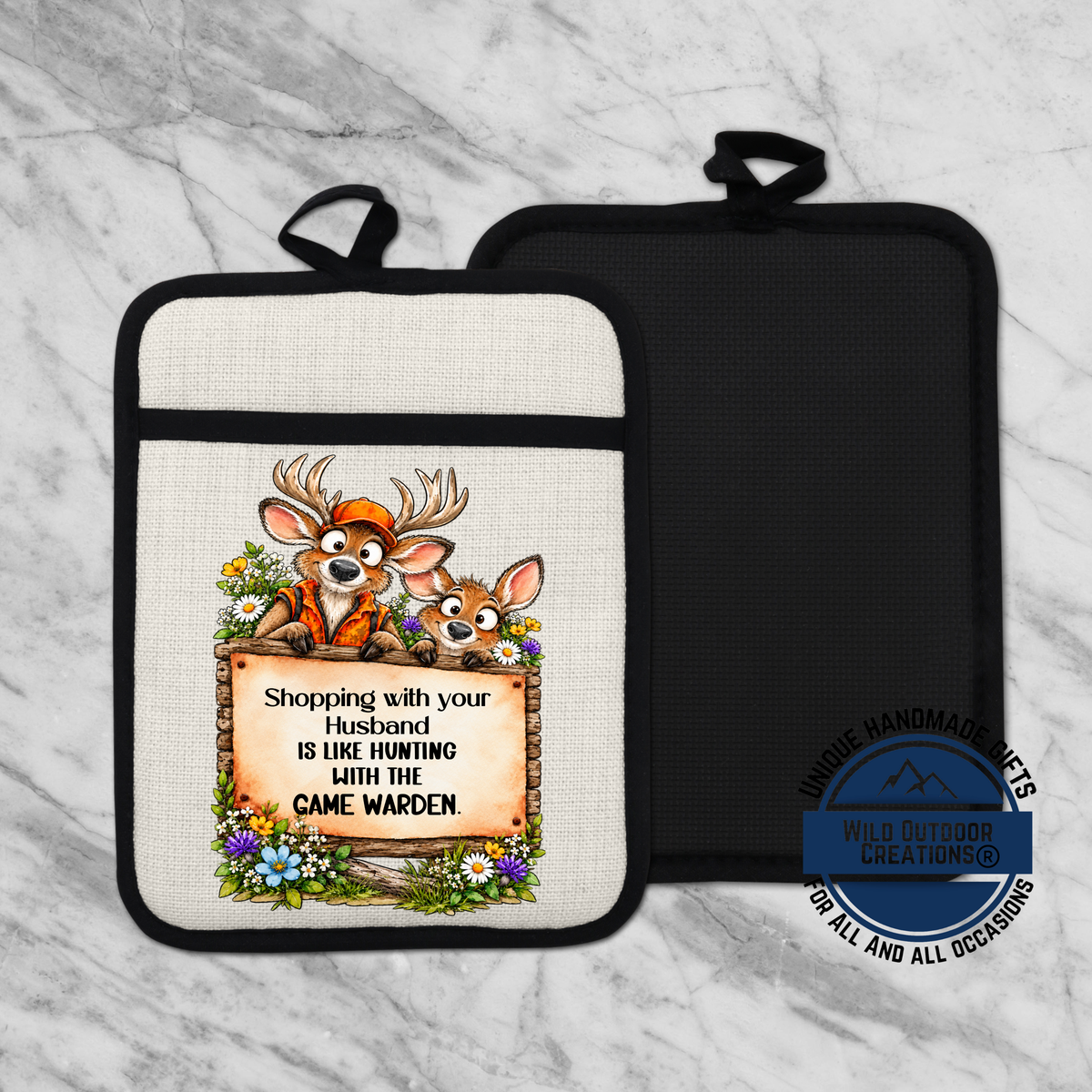 A kitchen pot holder with a cartoon image of two deer wearing orange clothing and a sign that says "Shopping with your husband is like hunting with the came warden".