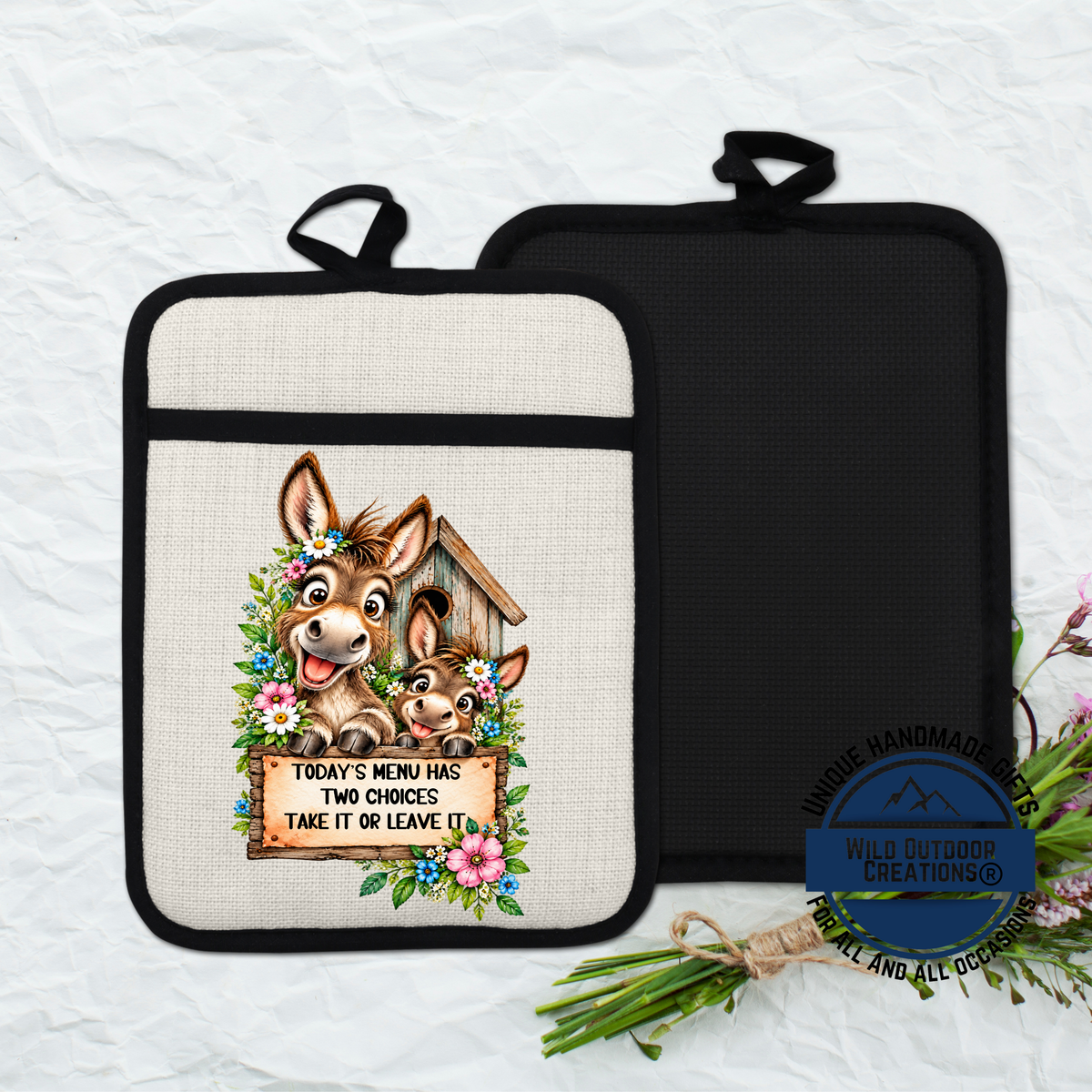 a beige pot holder with a cartoon donkey and a sign that says "Today's menu has two choices take it or leave it".