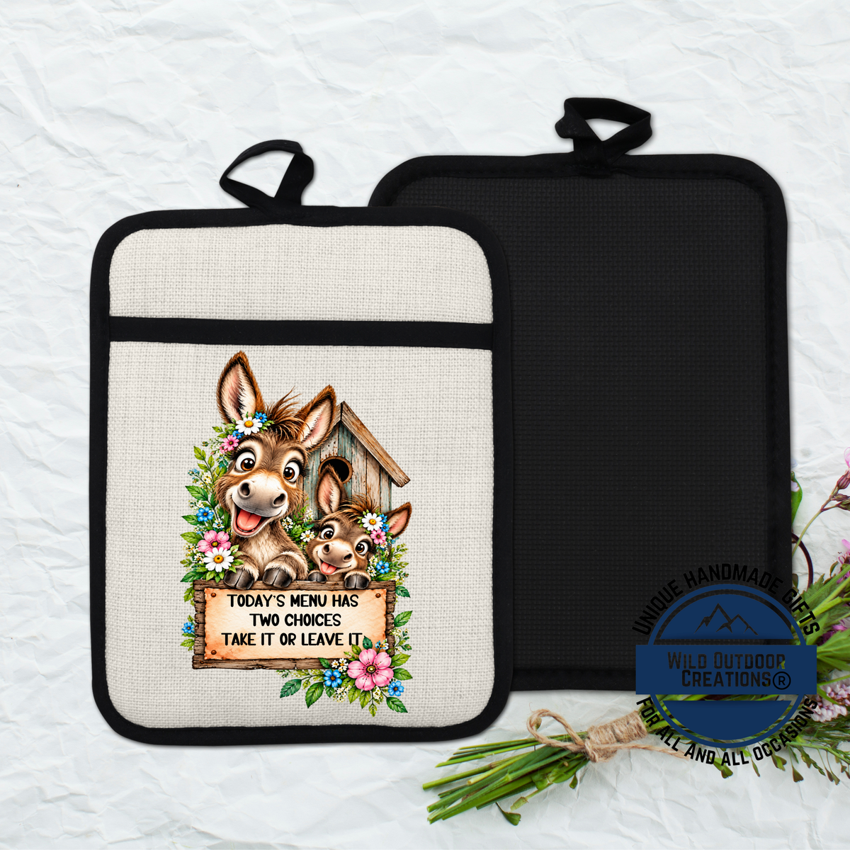 a kitchen pot holder with a cartoon donkey and a sign that says "Today's menu has two choices take it or leave it".