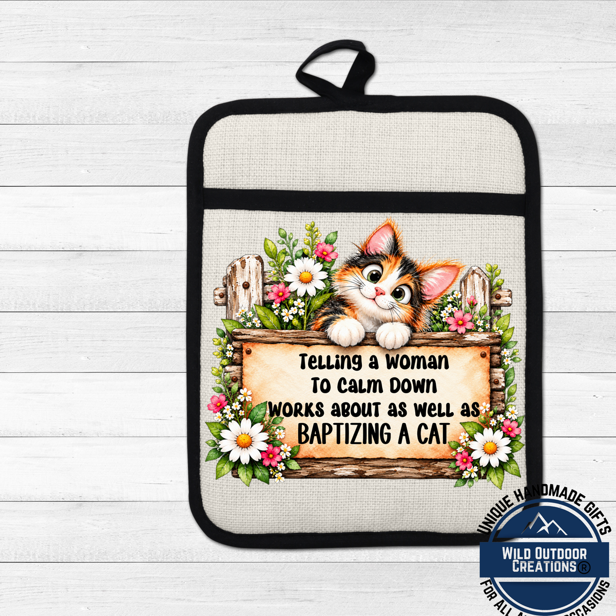 A kitchen pot holder with a cartoon cat and a sign that says "Telling a woman to calm down works about as well as baptizing a cat".