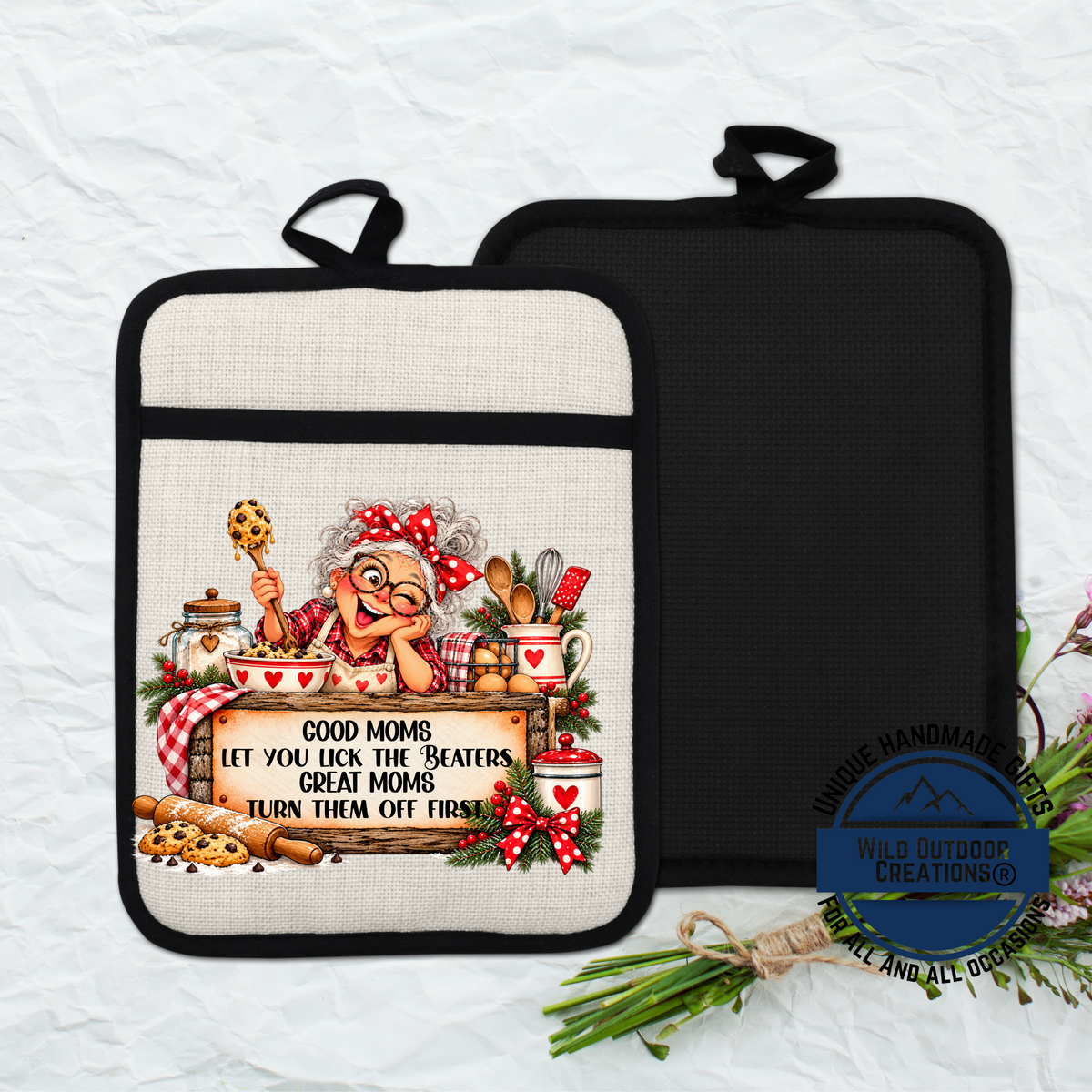 A kitchen pot holder with a cartoon image of an elderly woman and a sign that says "Good Moms let you lick the beaters, great Moms turn them off first".