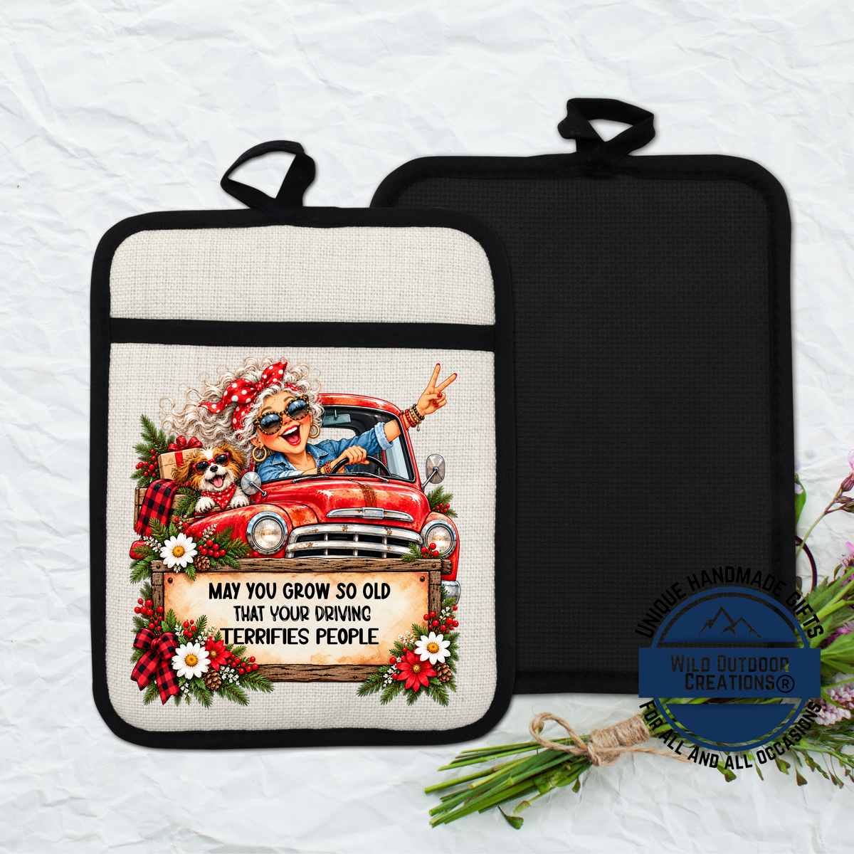 A pot holder with a cartoon image of an elderly woman driving a truck, along with the text "May you grow so old that your driving terrifies people".