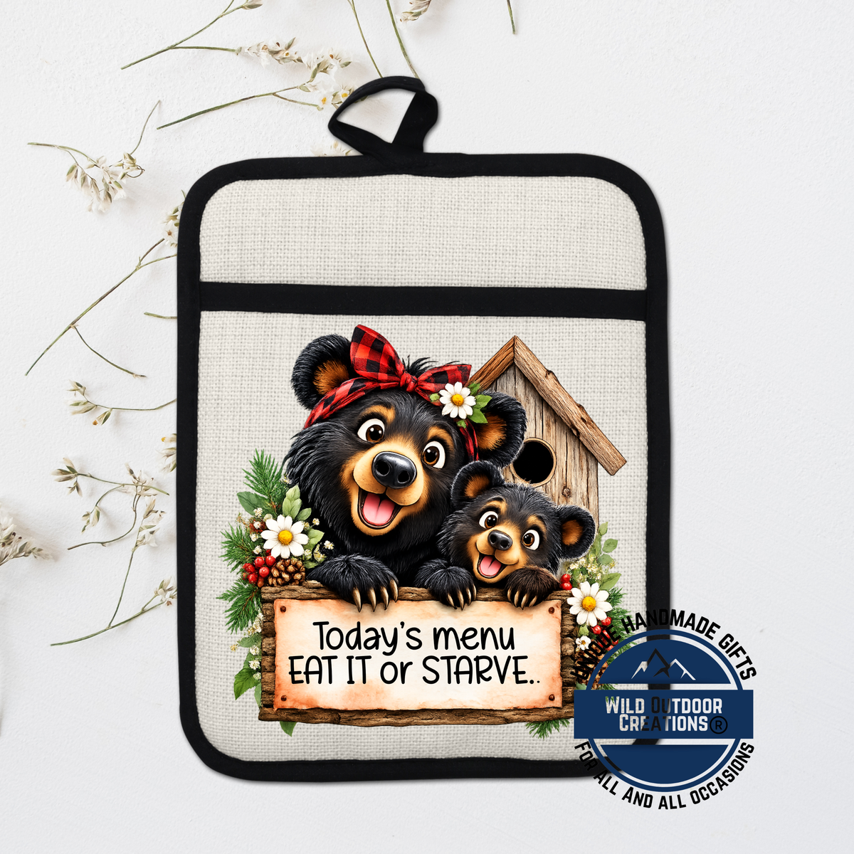 A kitchen pot holder with a cartoon image of a mother bear and her cub, along with a sign that says "Today's menu eat it or Starve."