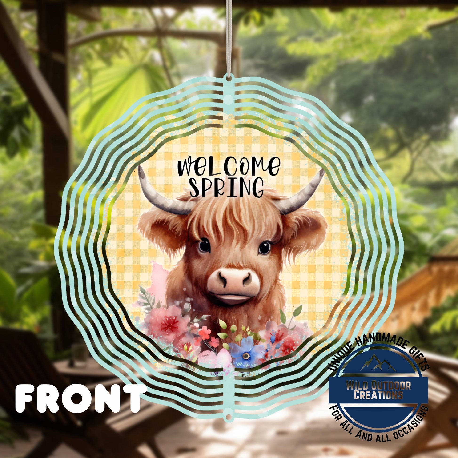 Highland Cow Spinner - Double Sided Outdoor Garden Decor with UV Protected Finish - shown spinning in outdoor garden setting