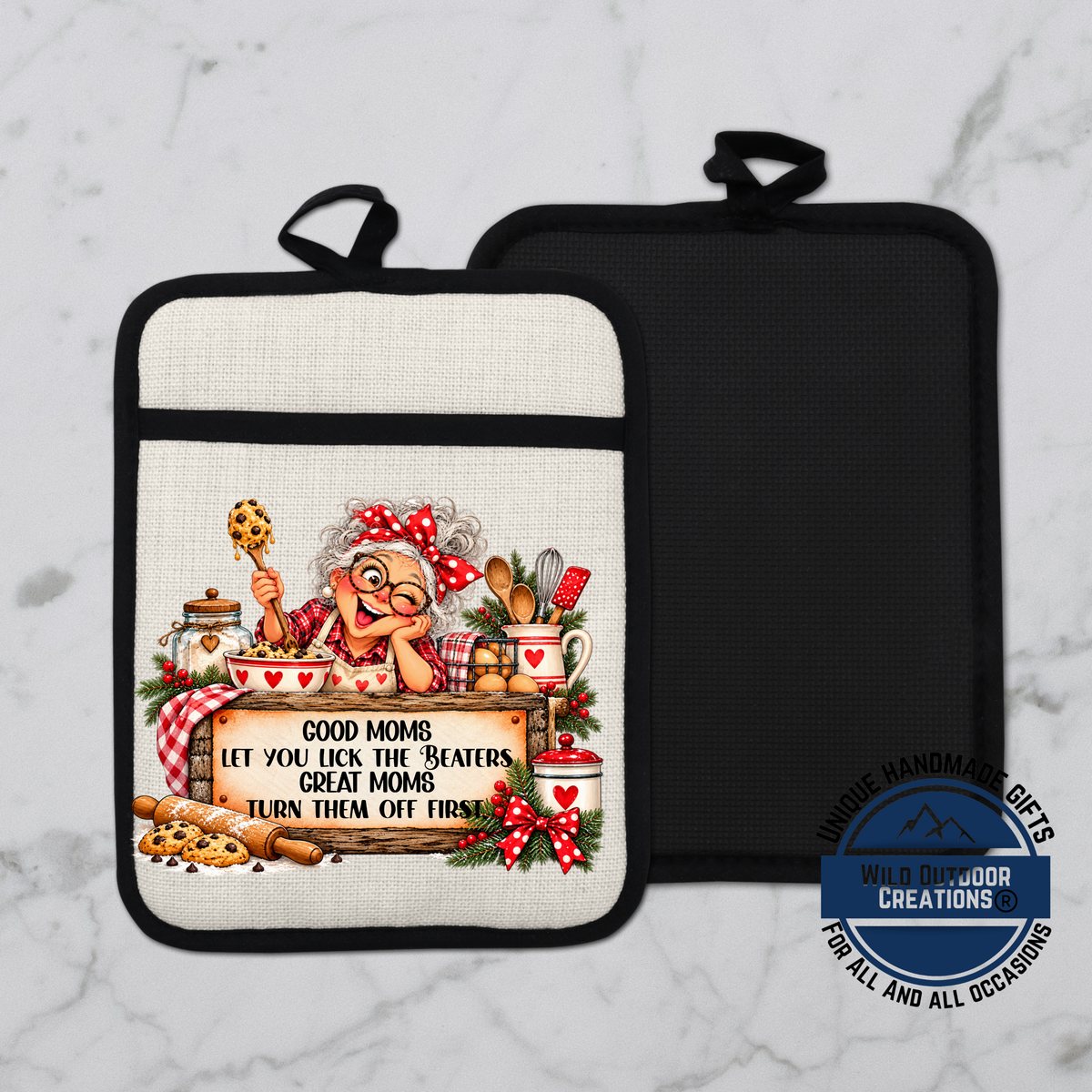 A white and black oven mitt with a printed design of an elderly woman cooking and holding a sign that says "Good Moms let you lick the beaters, great Moms turn them off first".