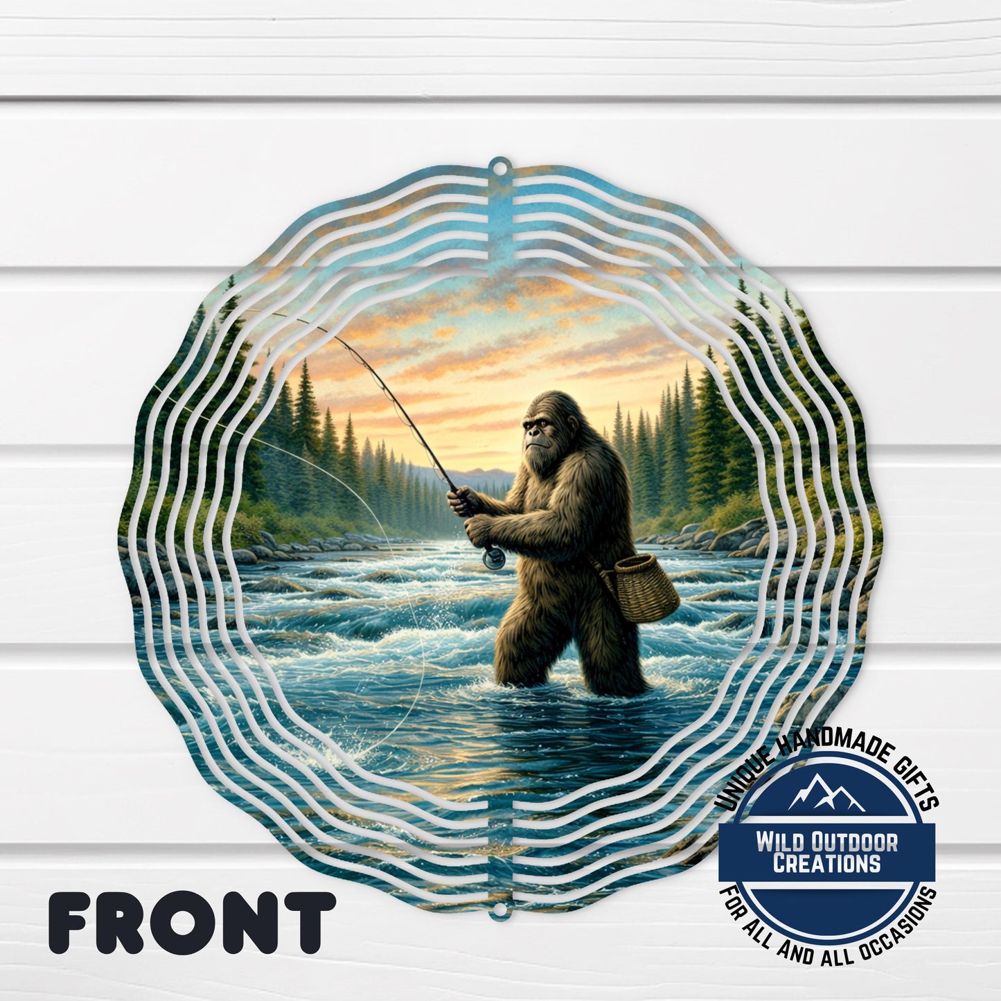 A wind chime with a painting of a giant Sasquatch fishing in a river, surrounded by a wavy border.