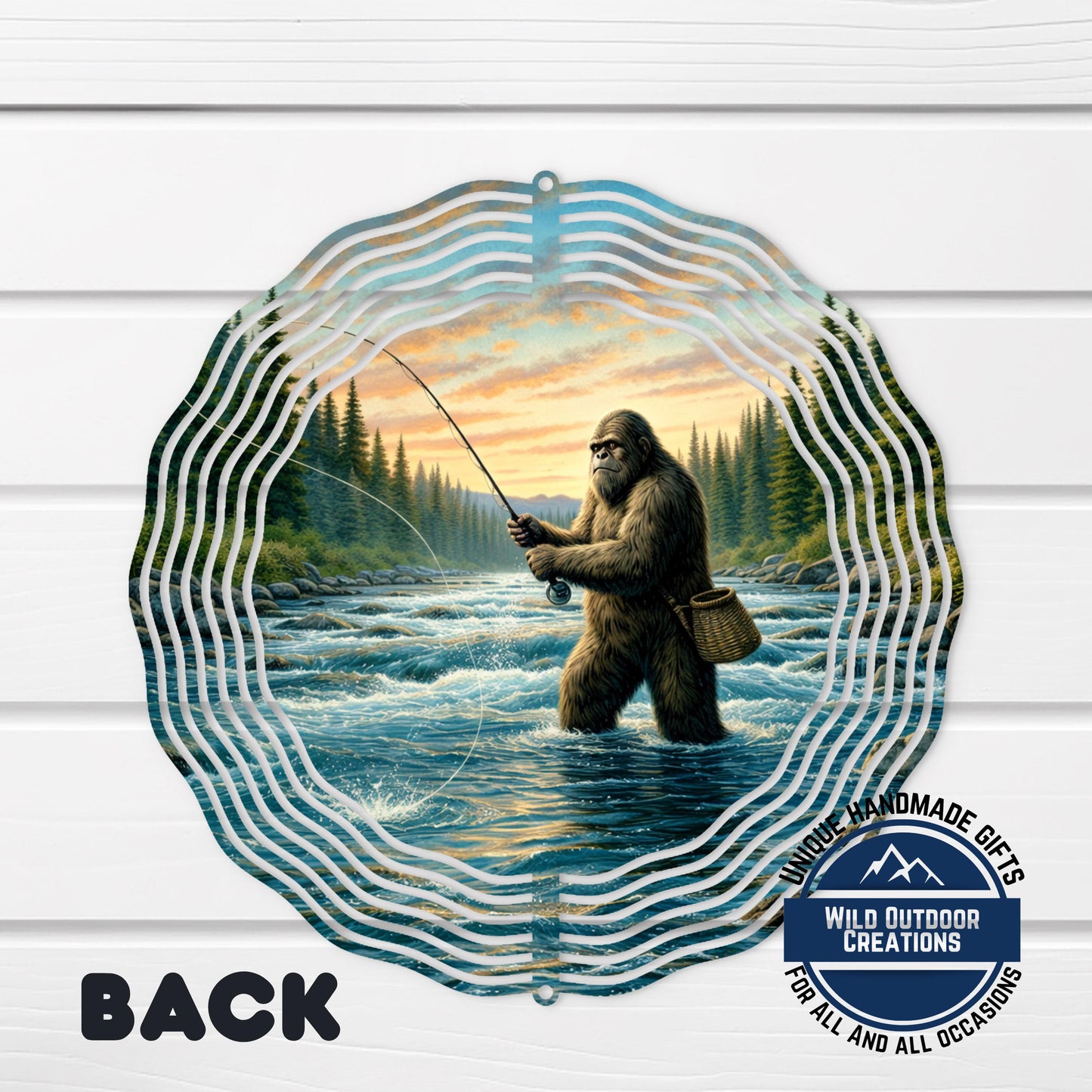 A large metal wind chime with a painting of a giant Sasquatch fishing in a river, surrounded by a wavy pattern.