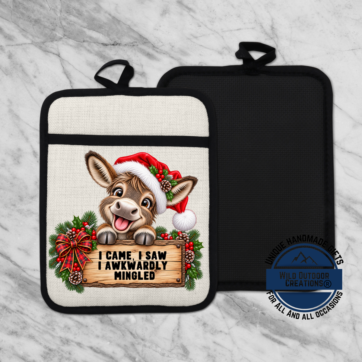 A white pot holder with a cartoon donkey wearing a Santa hat and holding a sign that says "I came, I saw, I Awkwardly mingled".