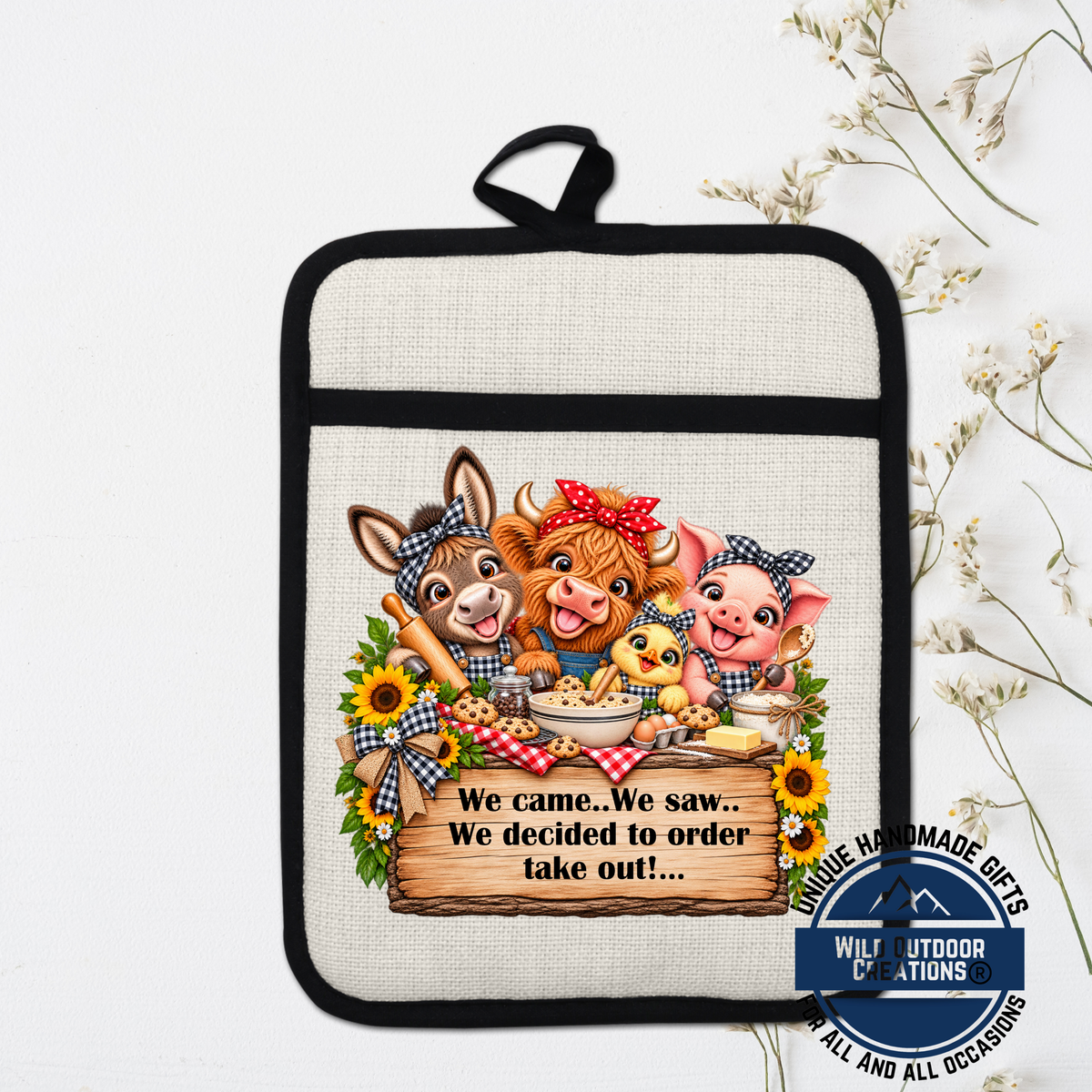 A kitchen pot holder with a cartoon illustration of farm animals, including a cow, pig, and chicken, along with a sign that says "We came. We saw. We decided to order take out..."
