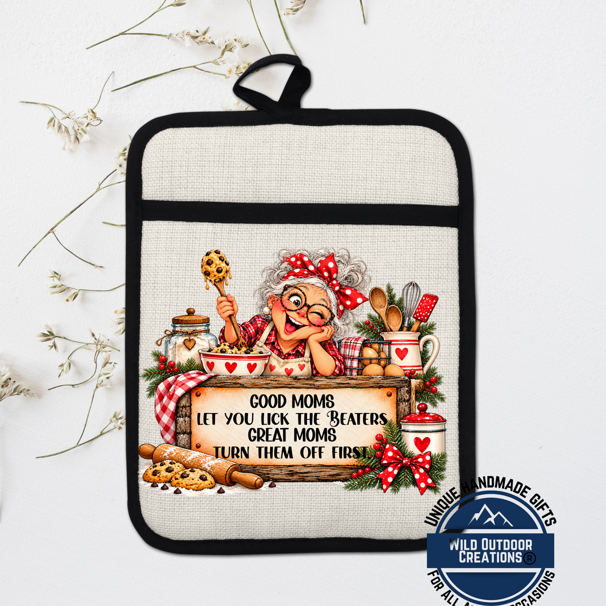 A hand-painted pot holder featuring an illustration of an elderly woman cooking, with a sign that says "Good Moms let you lick the Beaters, Great Moms turn them off first".