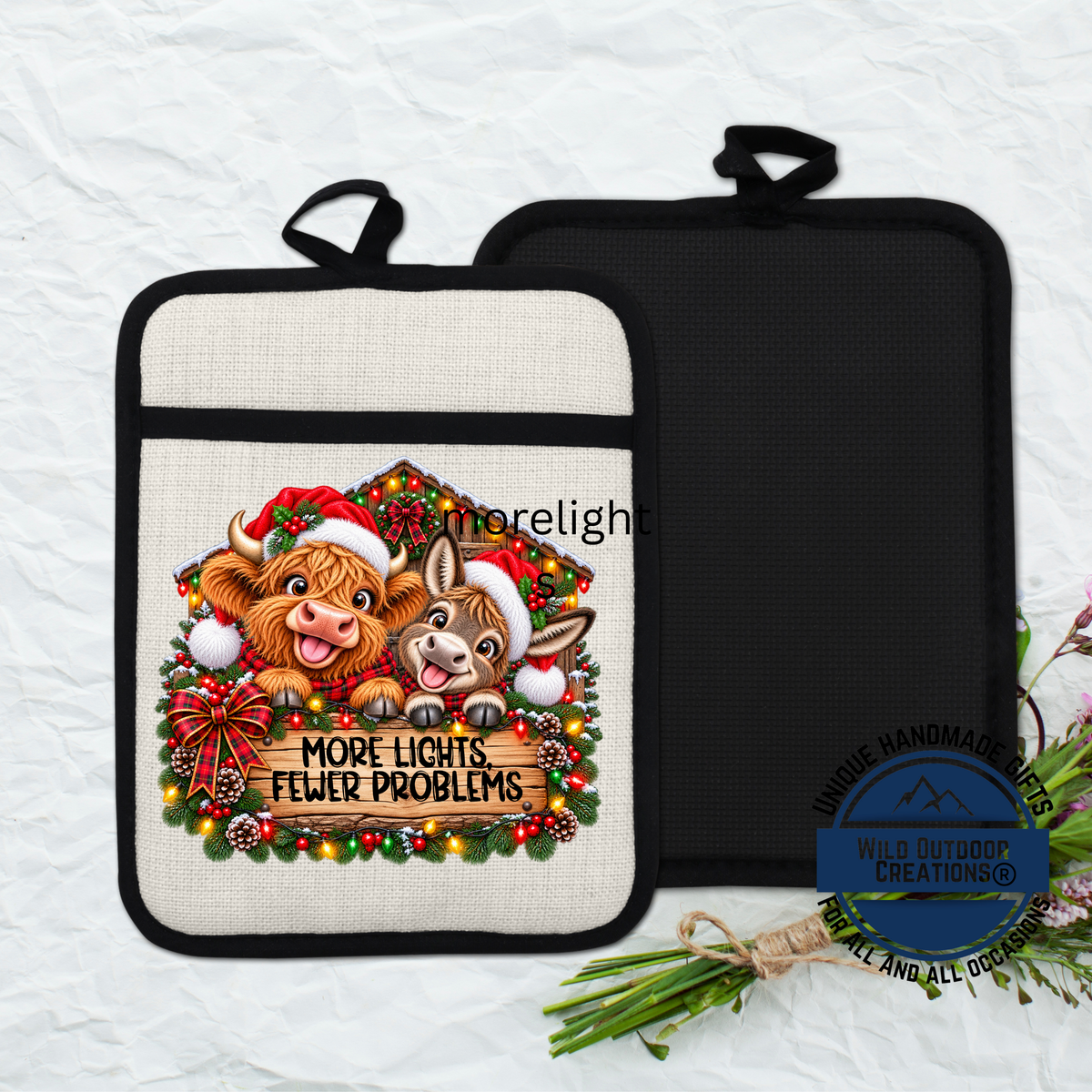 A beige pot holder with a Christmas-themed design featuring two cartoon animals, a cow and a dog, wearing Santa hats and surrounded by a wreath of Christmas lights and ornaments.