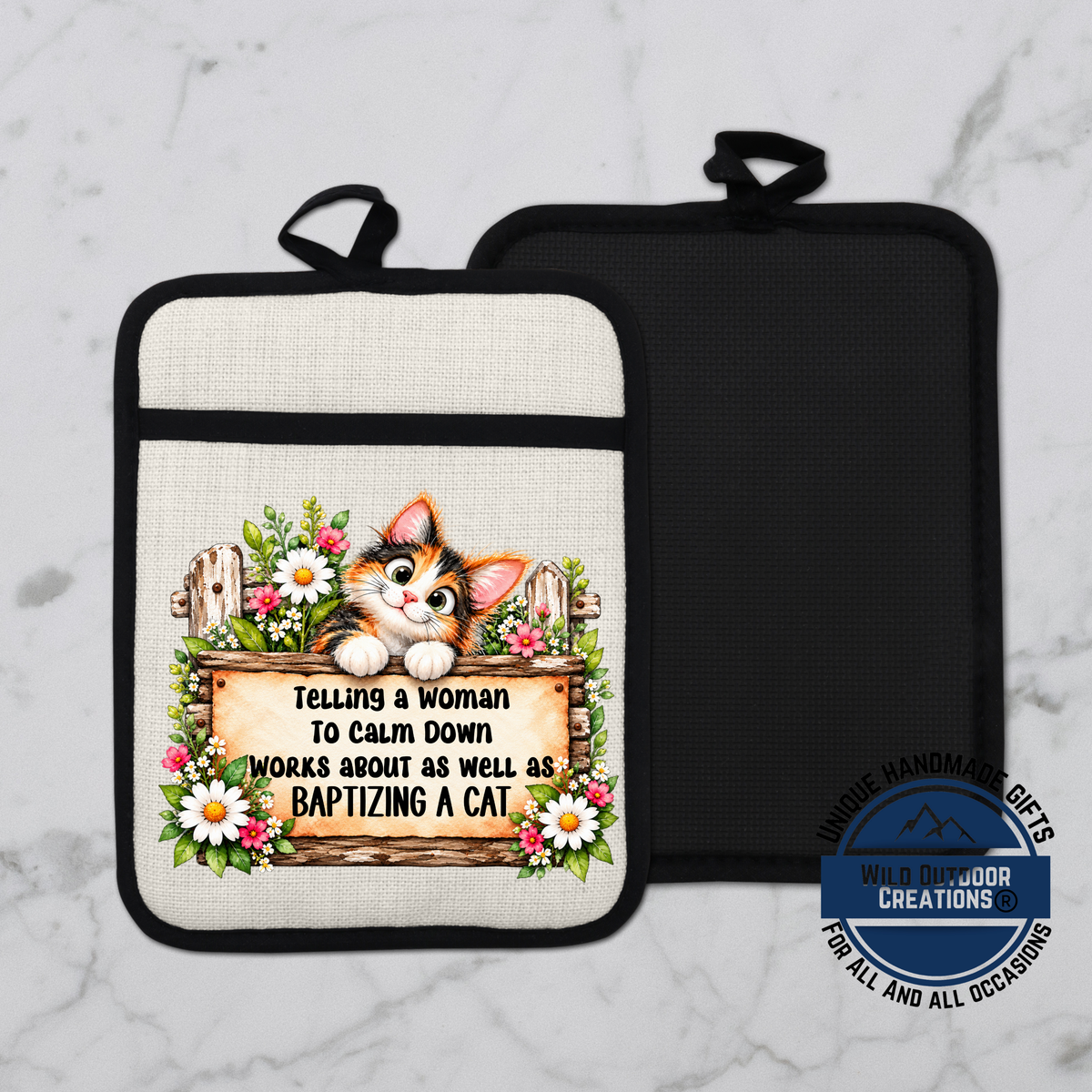 A kitchen pot holder with a printed design featuring a cat and a wooden sign with the text "Telling a woman to calm down works about as well as baptizing a cat".
