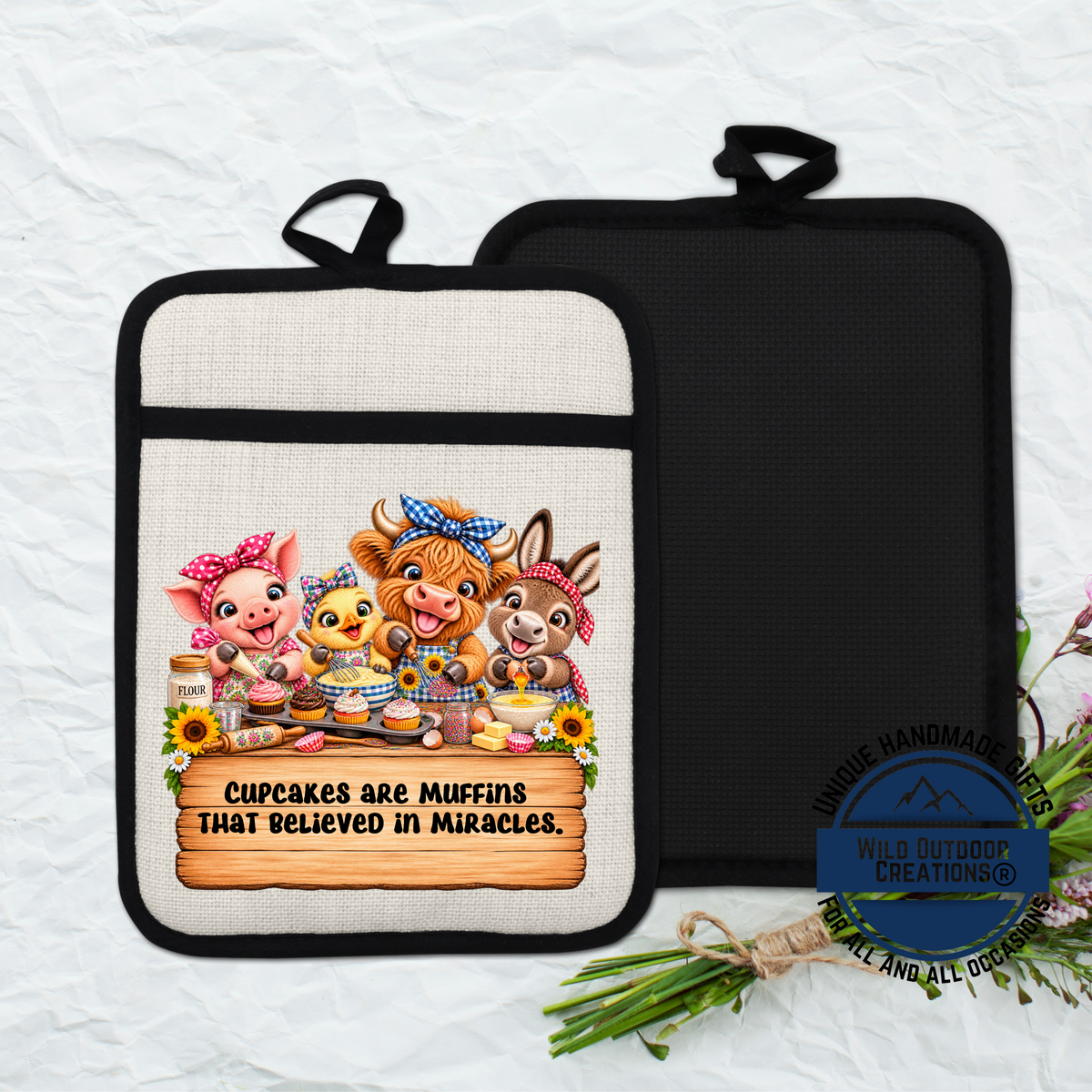 A kitchen pot holder with a cartoon illustration of animals, including a pig, chicken, cow, and rabbit, along with the text "Cupcakes are muffins that believed in miracles".
