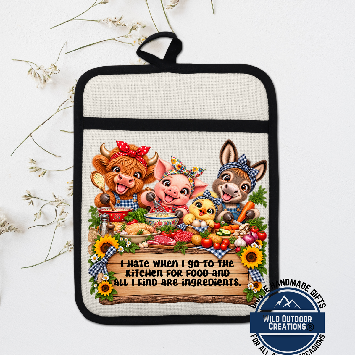 A kitchen pot holder with a cartoon illustration of a cow, pig, and chicken, along with a message that says "I hate when I go to the kitchen for food and all I find are ingredients."