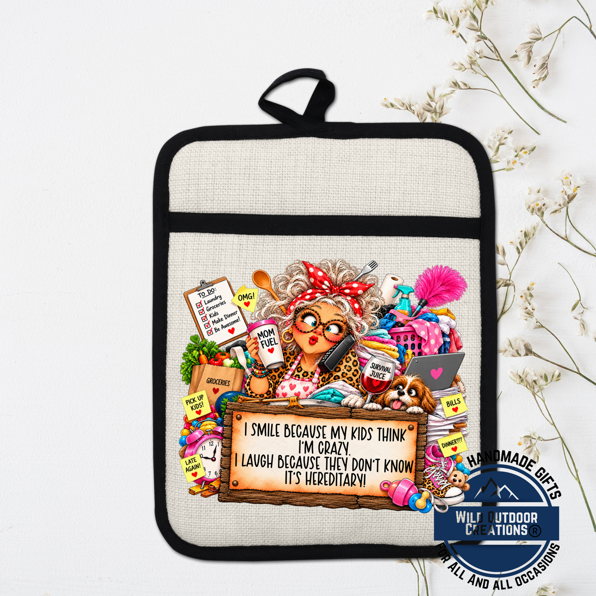 A hand-painted pot holder with a cartoon illustration of a woman surrounded by various objects, including a sign that reads "I smile because my kids think I'm crazy, I laugh because they don't know it's edgy, it's everywhere!".