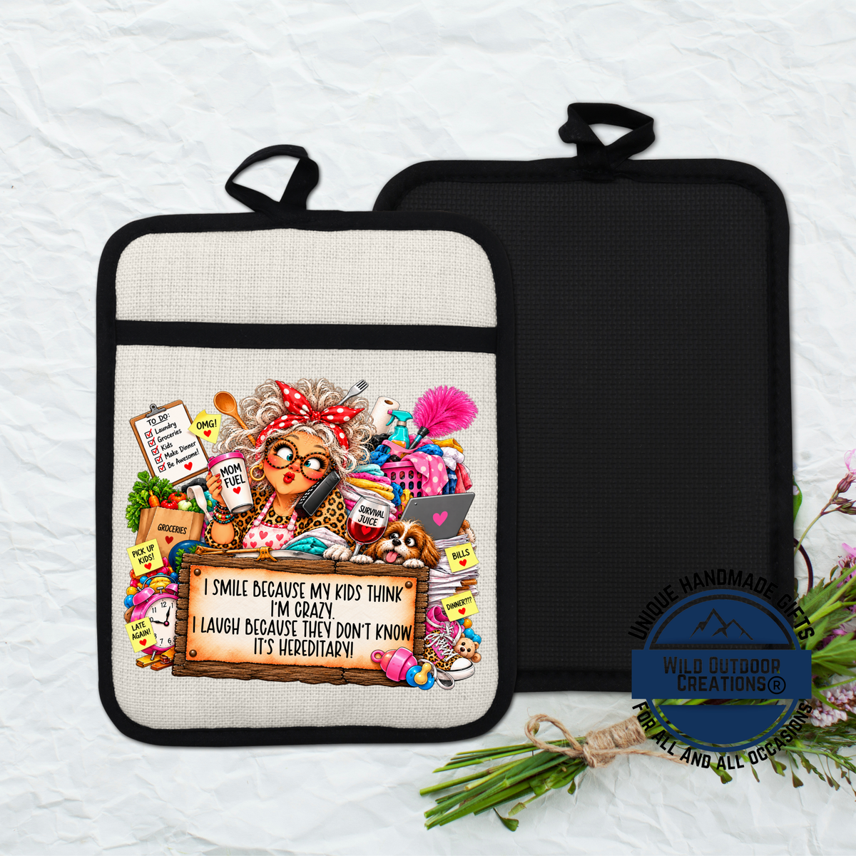 a beige oven mitt with a colorful illustration of an elderly woman surrounded by various objects, including a sign that reads "I smile because my kids think I'm crazy, I'm tired, I don't know it'shereditary!"