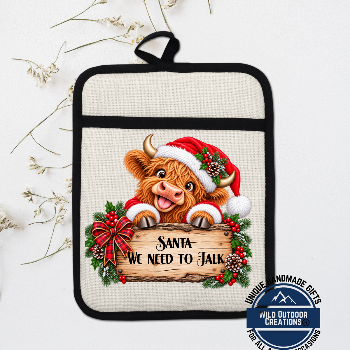 Santa cow wearing a Santa hat and holding a sign that says "Santa we need to talk"