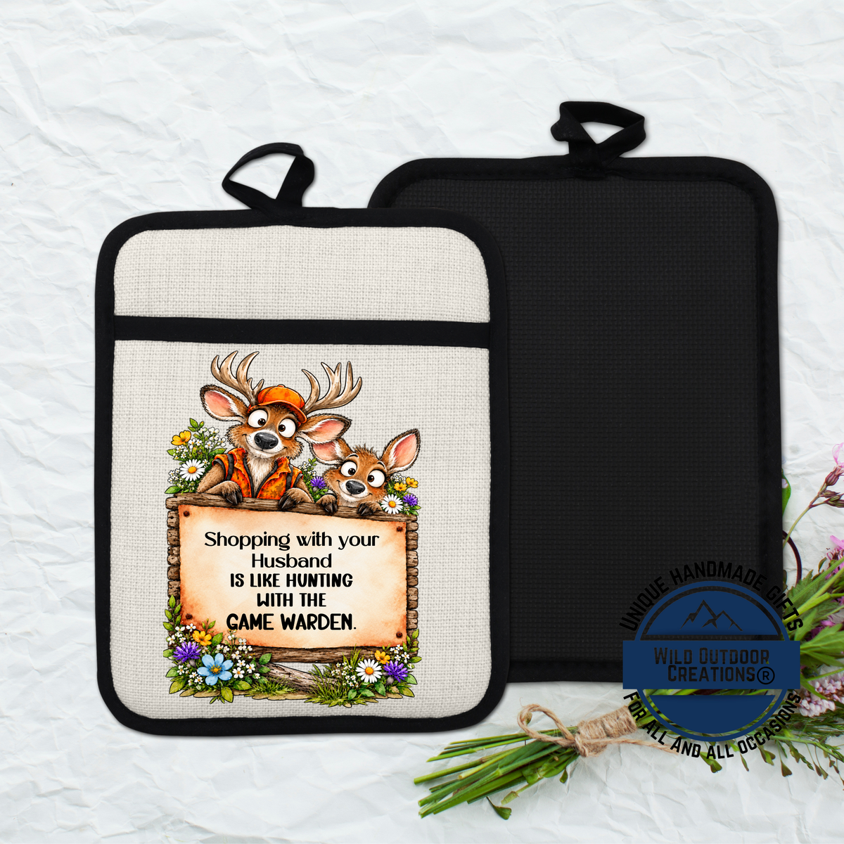 A beige pot holder with a cartoon image of two deer and a sign that reads "Shopping with your husband is like hunting with the camewolf".