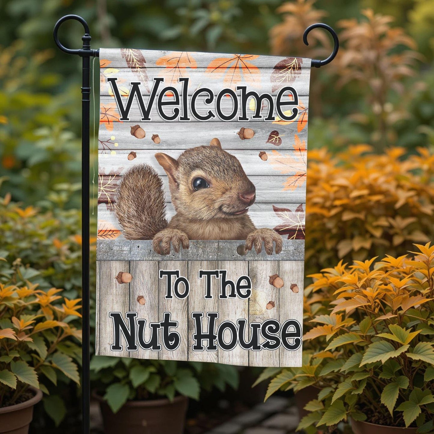 A garden sign with a squirrel on it, displaying the text "Welcome to the Nut House".