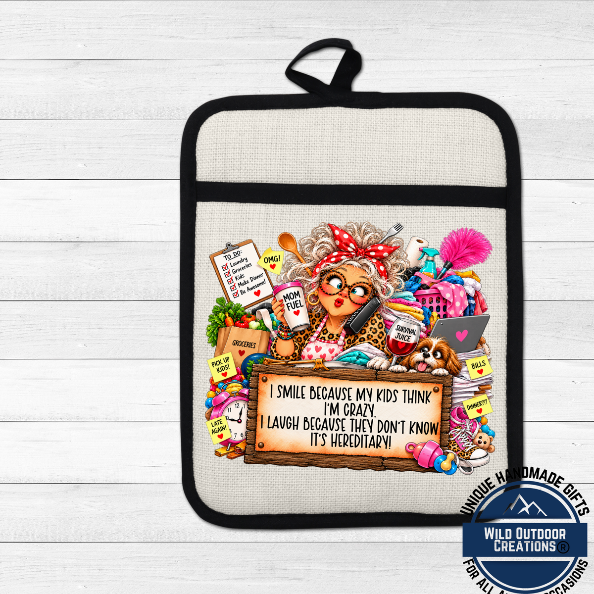 A humorous and whimsical oven mitt featuring a cartoon illustration of a woman with curly hair, glasses, and a red bow in her hair. The mitt is surrounded by various objects and text, including a sign that reads "I smile because my kids think I'm crazy, I laugh because they don't know it's heretic!"