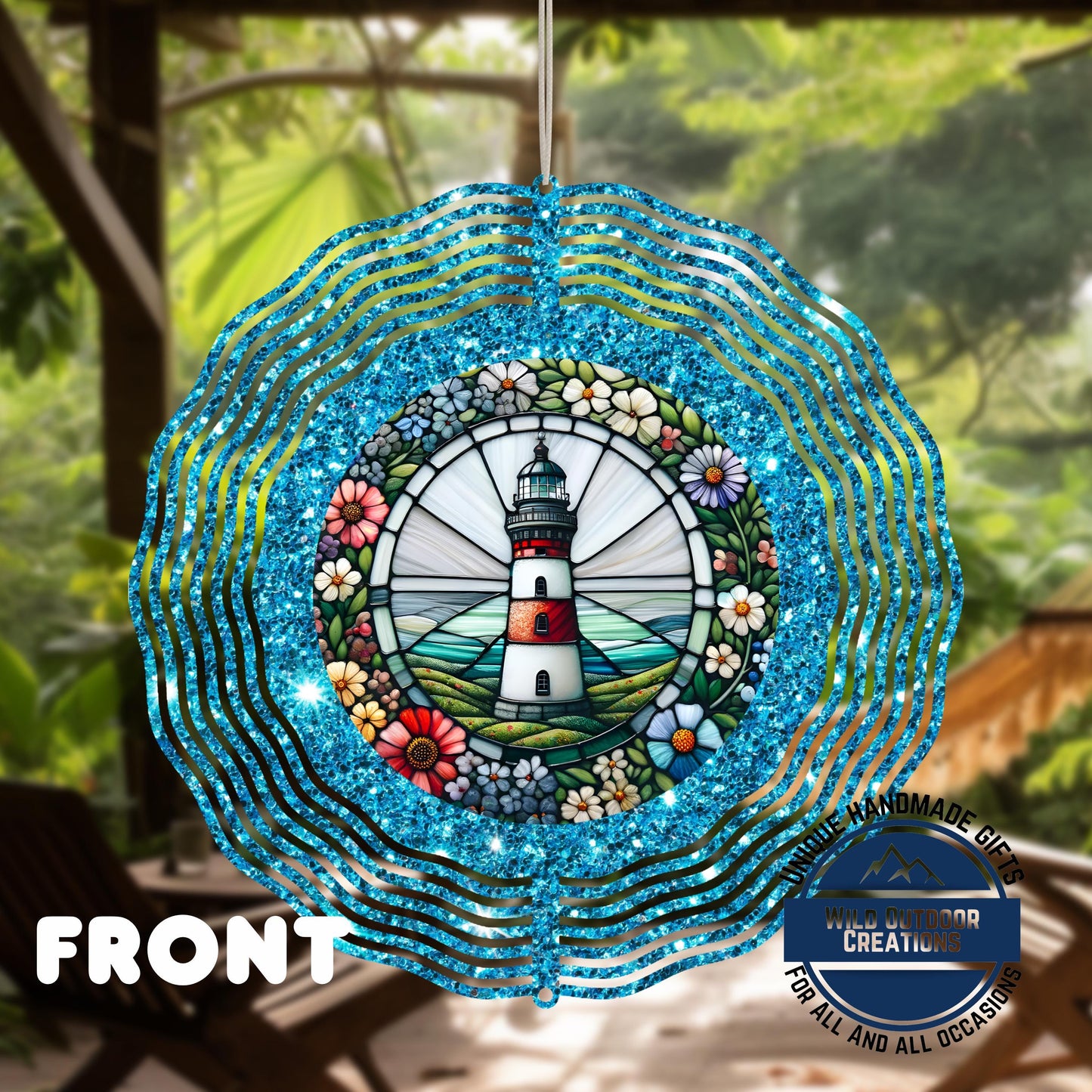 Coastal Lighthouse Wind Spinner – Aluminum Outdoor Garden Decor with Blue Glitter - shown spinning in outdoor garden setting