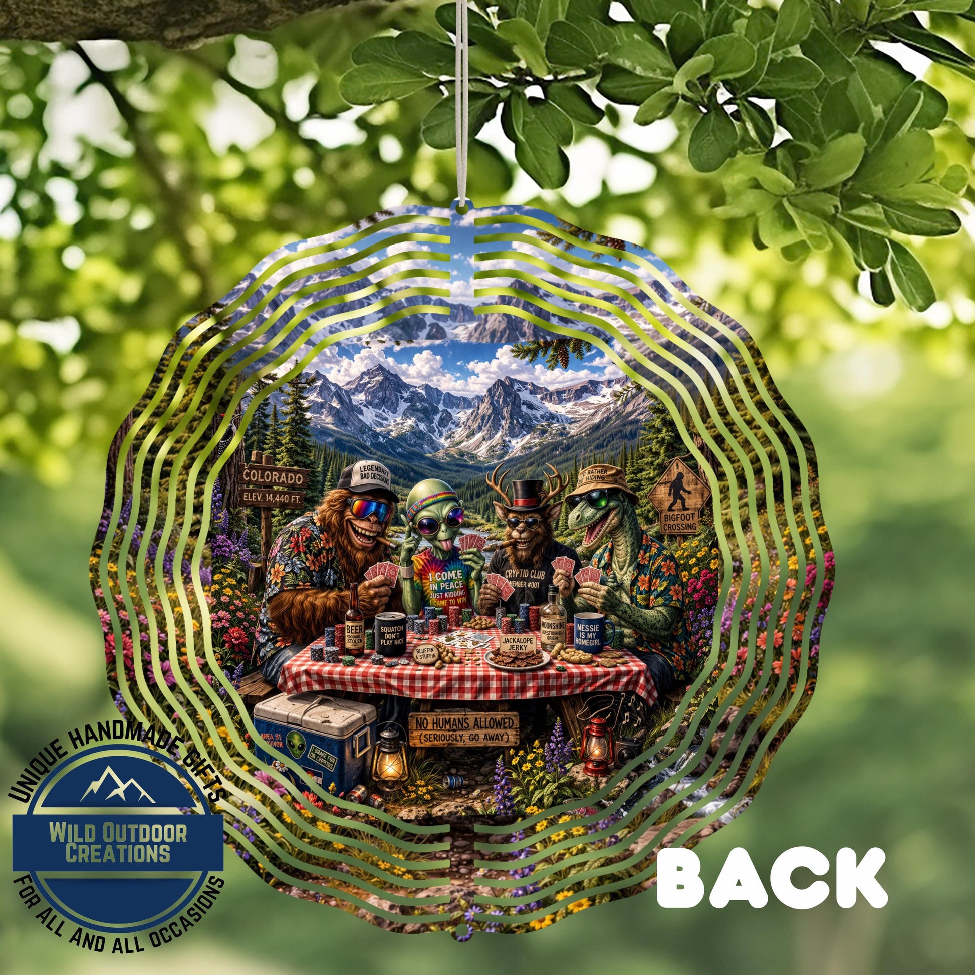 A whimsical outdoor scene featuring a group of animals gathered around a picnic table, surrounded by a forest and mountains in the background.