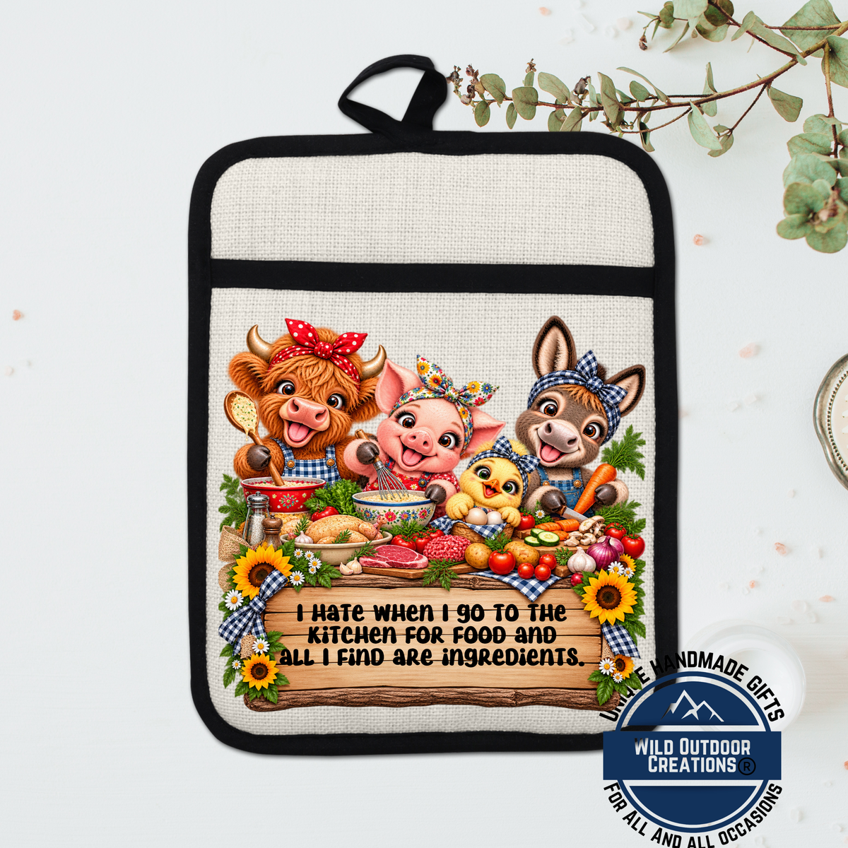 A hand-made oven mitt featuring a cartoon illustration of three animals, including a cow, pig, and chicken, surrounded by various food items and a sign that reads "I hate when I go to the kitchen for food and all I find are ingredients."