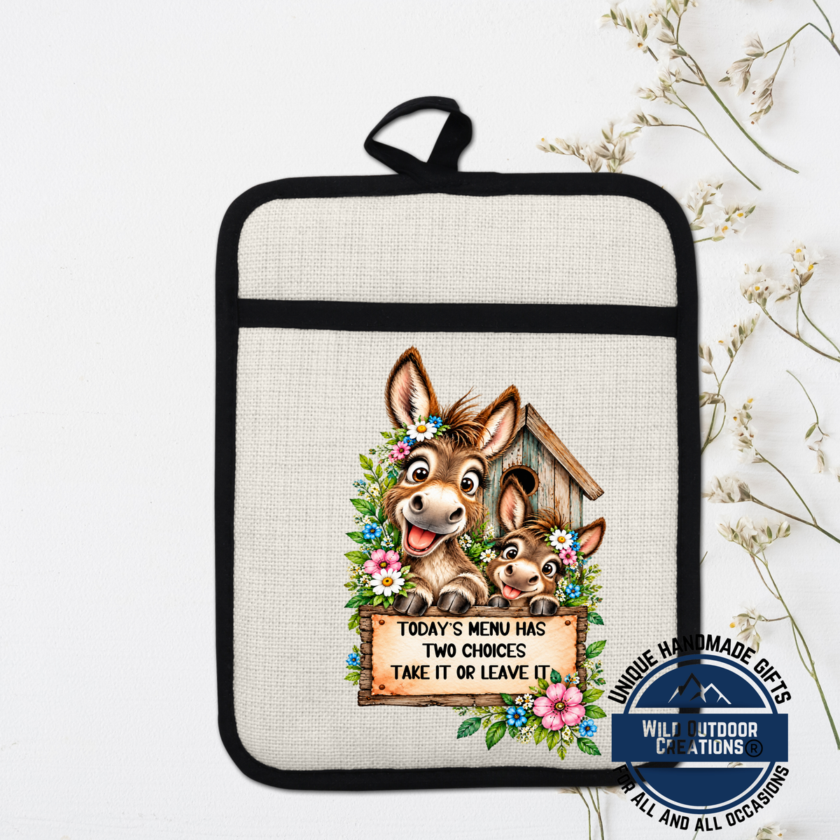 A kitchen pot holder with a cartoon donkey and a sign that says "Today's menu has two choices take it or leave it".