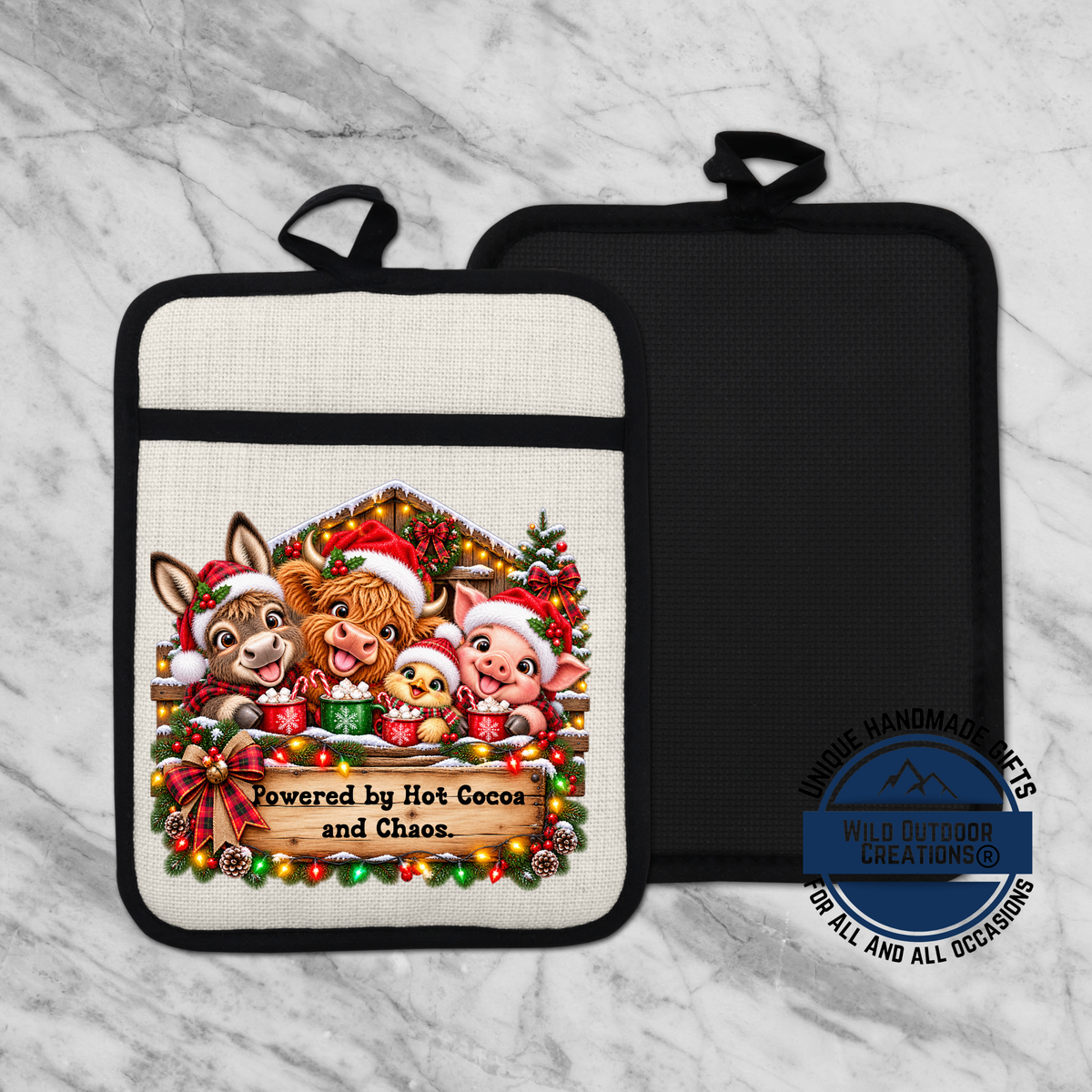 A kitchen pot holder with a festive design featuring cartoon animals, Christmas decorations, and the text "Powered by Hot Cocoa and Chaos."