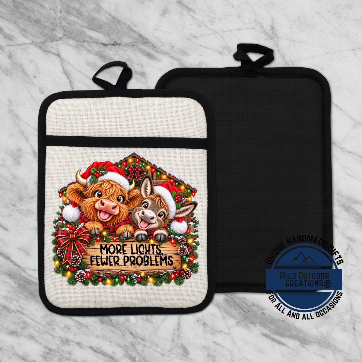 A kitchen pot holder with a Christmas-themed design featuring two cartoon animals, a cow and a dog, wearing Santa hats and surrounded by a wreath of lights and ornaments. The text on the pot holder reads "MORE LIGHTS FEWER PROBLEMS".
