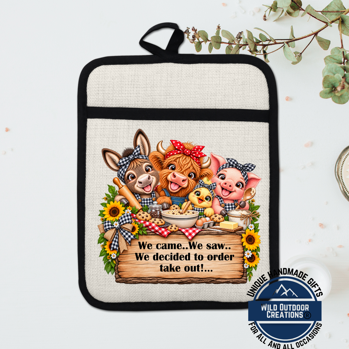 A kitchen pot holder with a cartoon illustration of farm animals, including a donkey, pig, and chicken, along with a sign that says "We came. We saw. We decided to order take out!".
