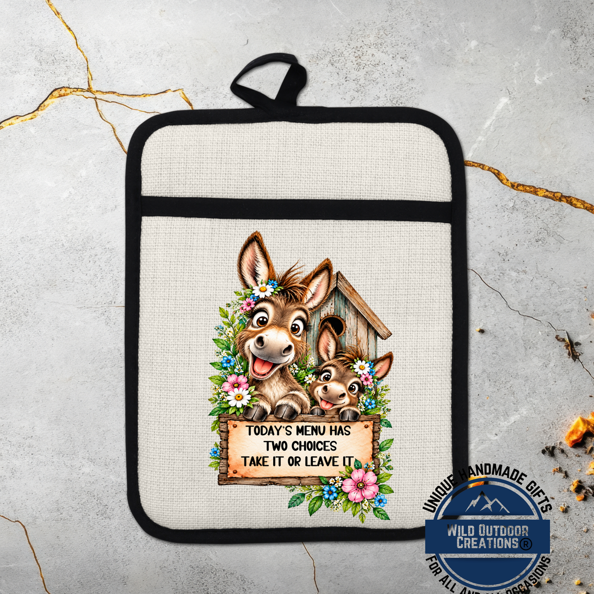 A beige oven mitt with a cartoon illustration of two donkeys and a wooden birdhouse, along with a sign that says "Today's menu has two choices take it or leave it".