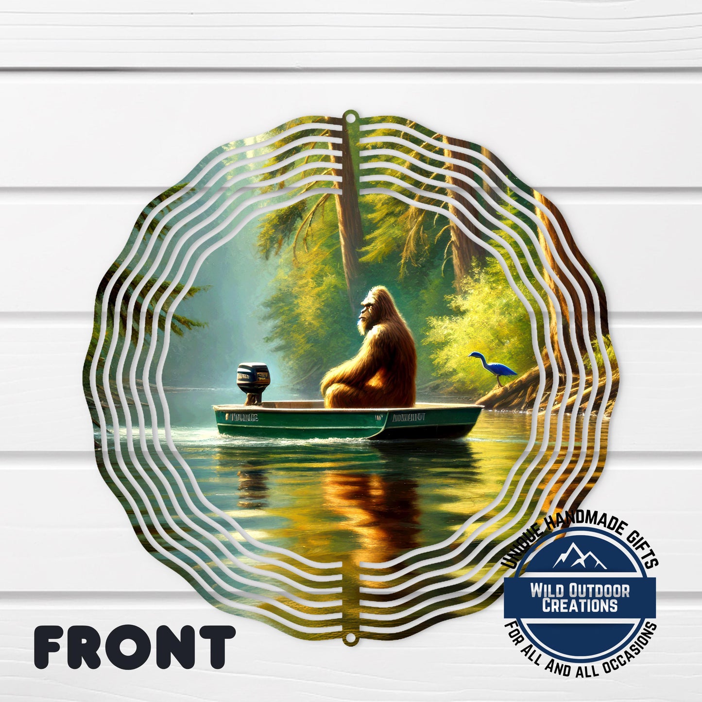 A large metal wind chime with a painting of a brown gorilla sitting in a boat on a river, surrounded by trees and a blue bird.