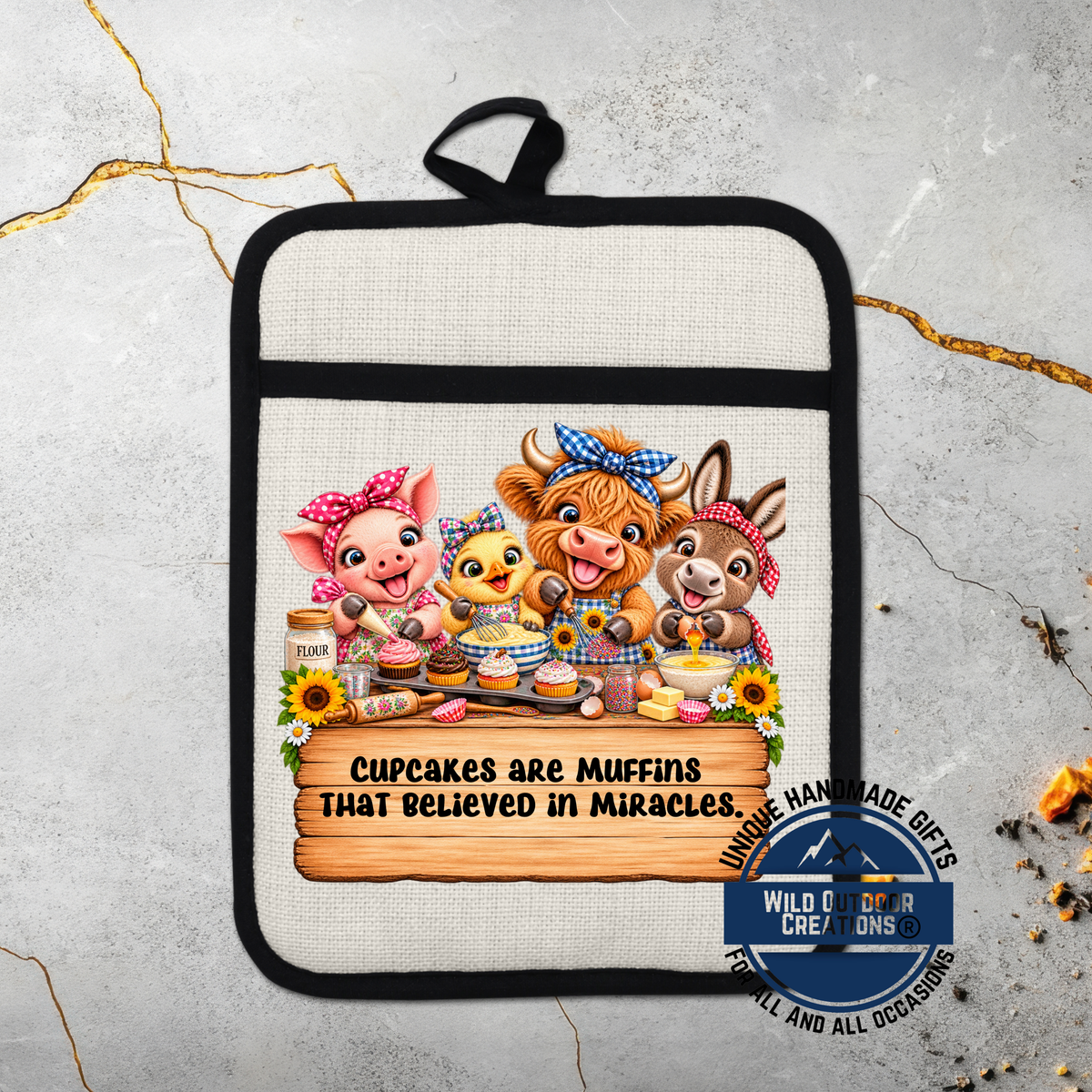 A hand-made pot holder featuring a cartoon illustration of four cute animals, including a pig, chicken, cow, and rabbit, along with the text "Cupcakes are Muffins that believed in Miracles".